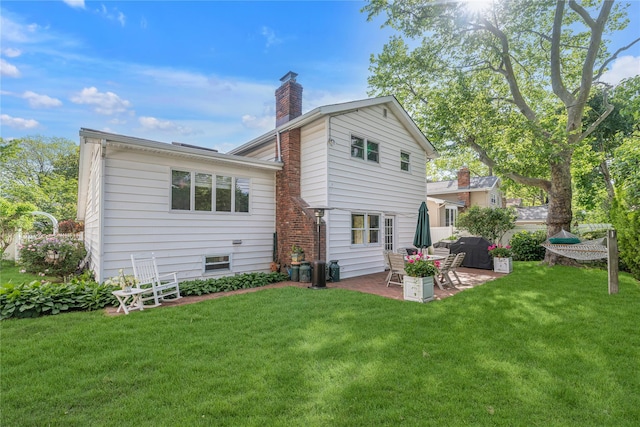 5 Seaview Ln, Port Washington, NY 11050 - back of property with a patio, a chimney, and a yard