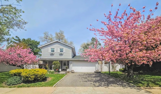 5 Seaview Ln, Port Washington, NY 11050 - traditional-style house with asphalt driveway, an attached garage, and covered porch