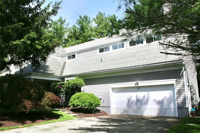 2 Greenwood Ct, Briarcliff Manor, NY 10510 - view of property exterior with roof with shingles, a garage, asphalt driveway, and a chimney