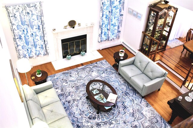 2 Greenwood Ct, Briarcliff Manor, NY 10510 - living room with baseboard heating, wood finished floors, and a premium fireplace