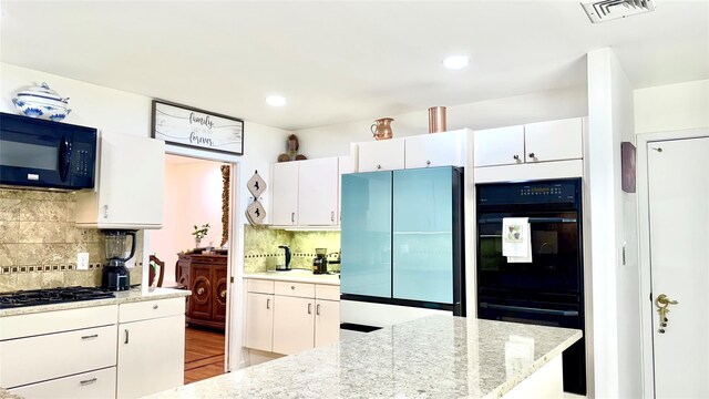 2 Greenwood Ct, Briarcliff Manor, NY 10510 - kitchen with black appliances, tasteful backsplash, white cabinetry, and recessed lighting