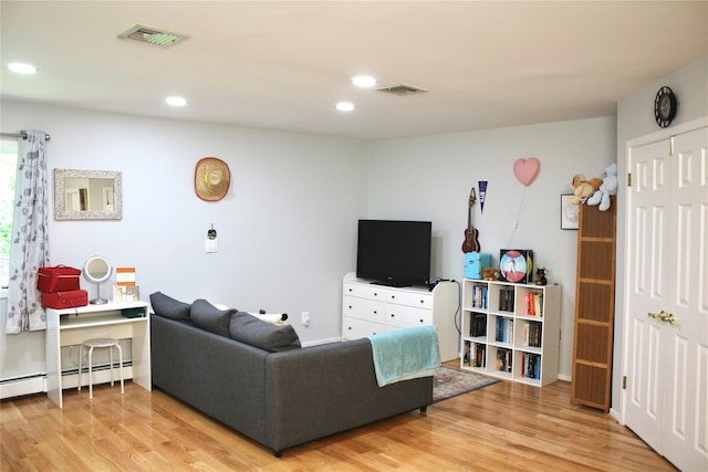 2 Greenwood Ct, Briarcliff Manor, NY 10510 - living room with a baseboard heating unit, wood finished floors, and recessed lighting