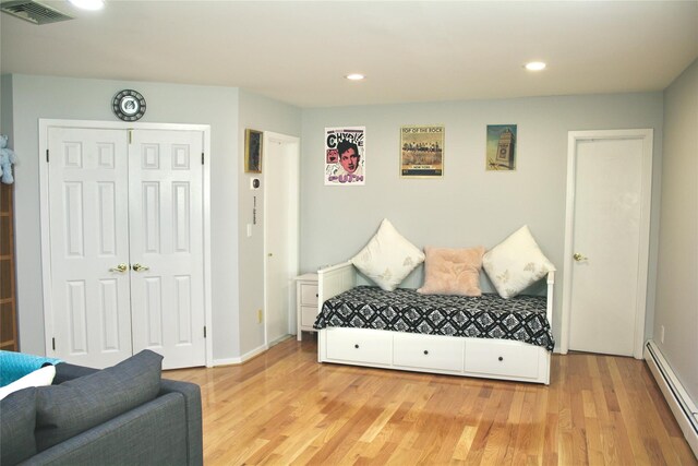 2 Greenwood Ct, Briarcliff Manor, NY 10510 - bedroom with baseboard heating, wood finished floors, recessed lighting, a closet, and baseboards