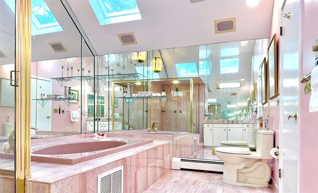 2 Greenwood Ct, Briarcliff Manor, NY 10510 - bathroom with baseboard heating, toilet, a skylight, a bath, and vanity