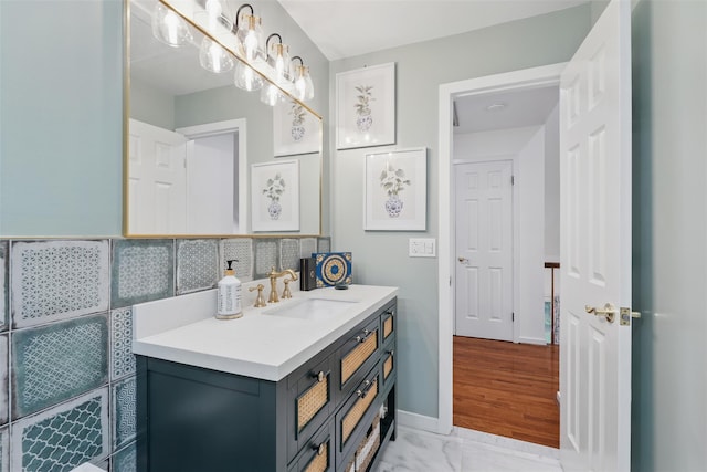 2 Greenwood Ct, Briarcliff Manor, NY 10510 - bathroom with vanity, marble look tiles, and tasteful backsplash