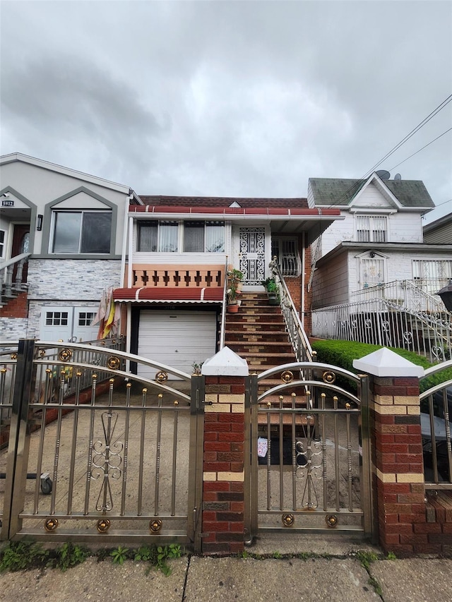 5910 Beverley Rd, Brooklyn, NY 11203 - townhome / multi-family property featuring a fenced front yard, stairs, a garage, and a gate