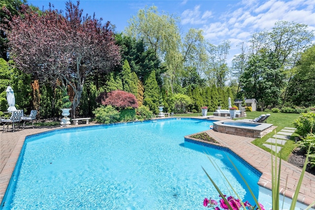 11 Crick Holly Ln, East Islip, NY 11730 - outdoor pool featuring an in-ground hot tub, a patio, an outdoor structure, and view of wooded area