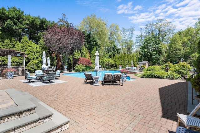 11 Crick Holly Ln, East Islip, NY 11730 - swimming pool with a patio area, a pergola, and view of scattered trees