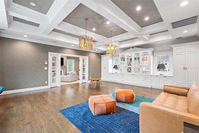 11 Crick Holly Ln, East Islip, NY 11730 - living area featuring crown molding, plenty of natural light, a chandelier, coffered ceiling, and wood finished floors