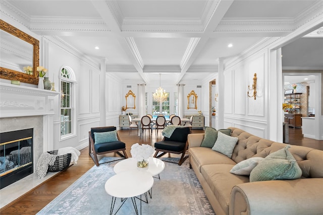 11 Crick Holly Ln, East Islip, NY 11730 - living room featuring crown molding, a decorative wall, beam ceiling, wood finished floors, and a premium fireplace