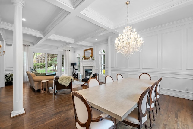 11 Crick Holly Ln, East Islip, NY 11730 - dining space featuring decorative columns, a decorative wall, a glass covered fireplace, beamed ceiling, and dark wood-style floors