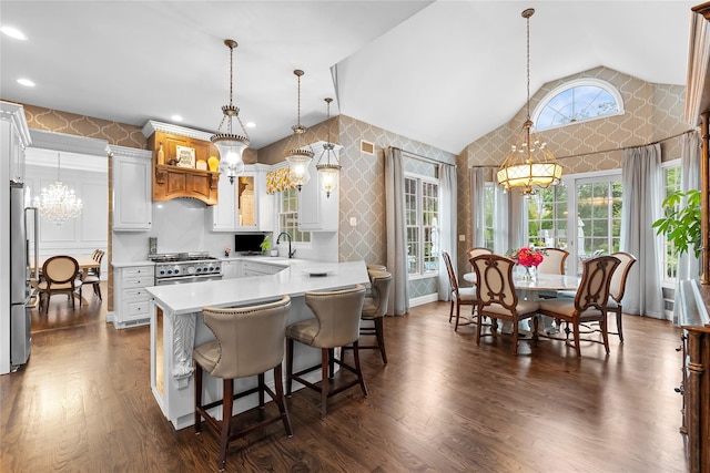11 Crick Holly Ln, East Islip, NY 11730 - kitchen with a chandelier, wallpapered walls, appliances with stainless steel finishes, lofted ceiling, and light countertops