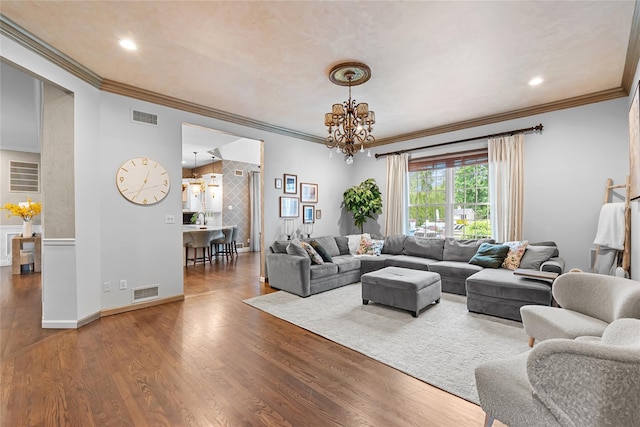 11 Crick Holly Ln, East Islip, NY 11730 - living room with crown molding, a chandelier, wood finished floors, recessed lighting, and baseboards