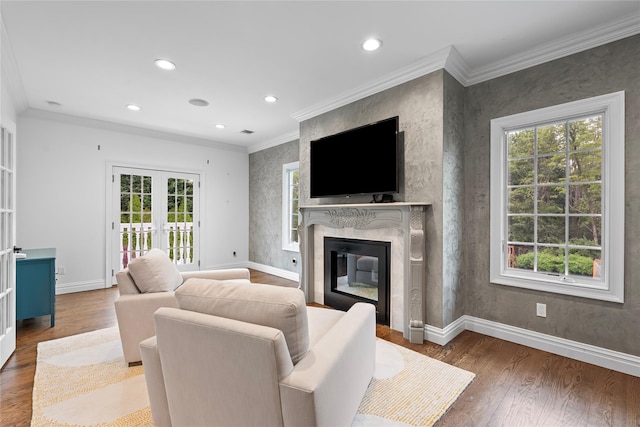 11 Crick Holly Ln, East Islip, NY 11730 - living area with healthy amount of natural light, a fireplace, french doors, wood finished floors, and ornamental molding
