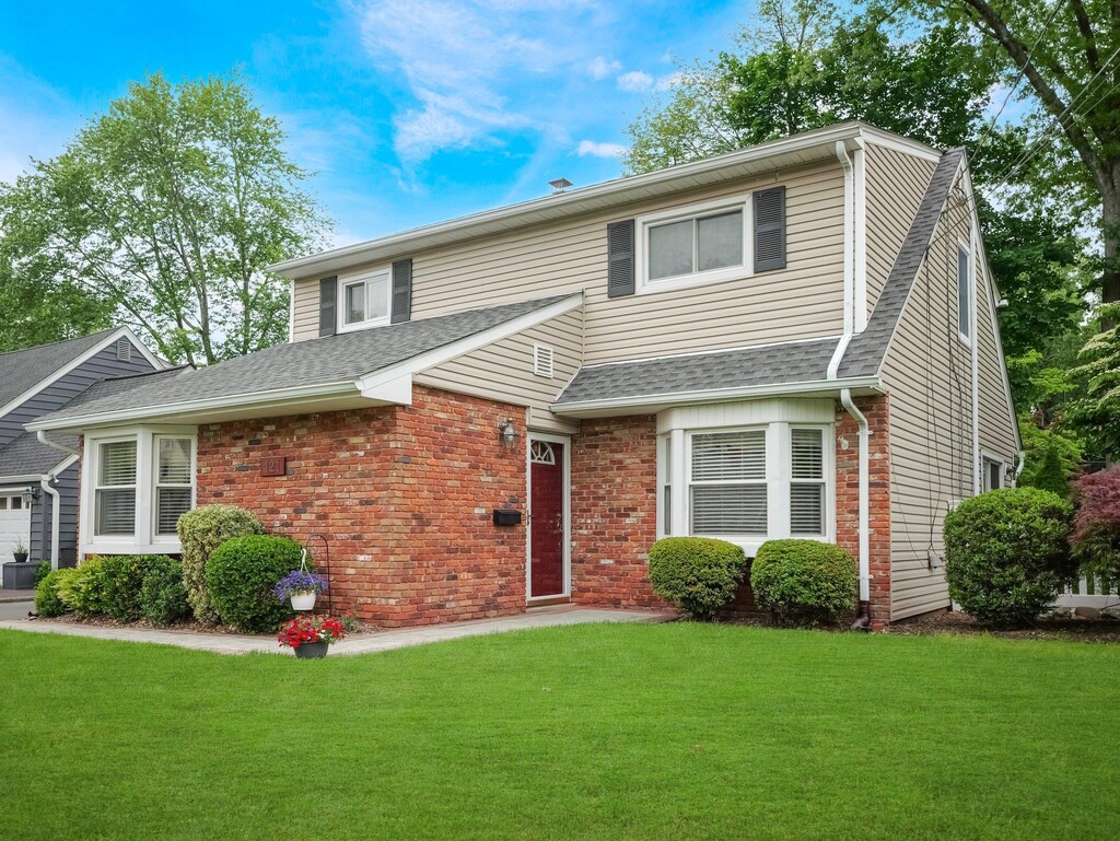 121 Bogert Ave, Pearl River, NY 10965 - traditional-style home with a front yard, roof with shingles, and brick siding