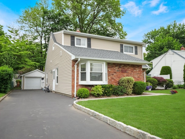 121 Bogert Ave, Pearl River, NY 10965 - traditional home with an outbuilding, a detached garage, brick siding, a front lawn, and driveway