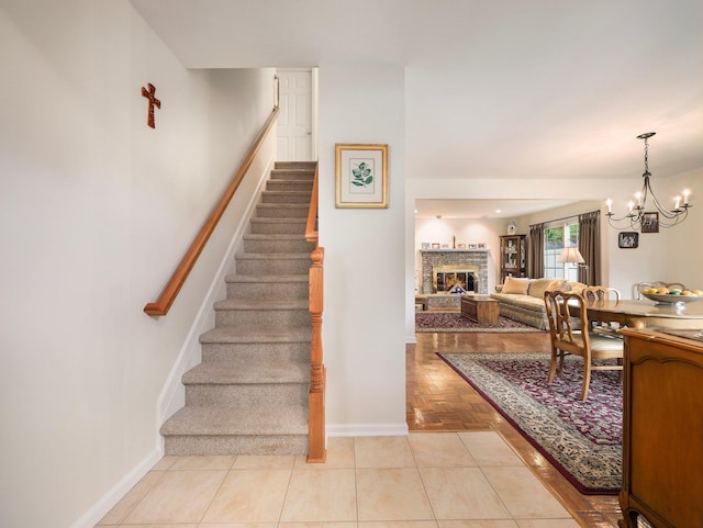 121 Bogert Ave, Pearl River, NY 10965 - stairway with baseboards, a chandelier, and a glass covered fireplace