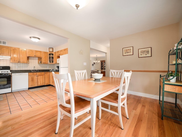 121 Bogert Ave, Pearl River, NY 10965 - dining room featuring light wood-type flooring and a chandelier