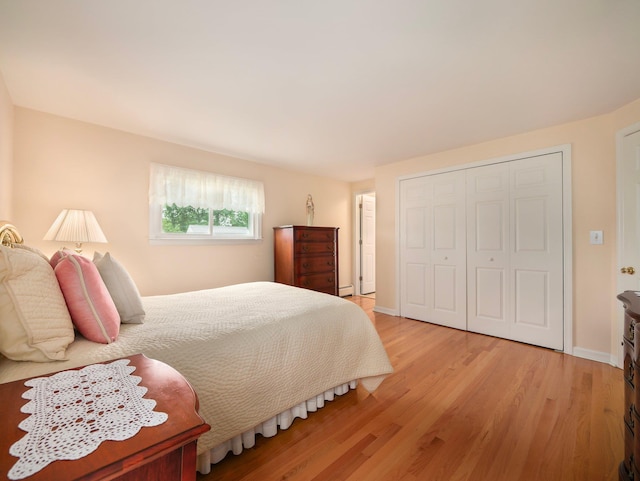 121 Bogert Ave, Pearl River, NY 10965 - bedroom featuring light wood-type flooring, a closet, a baseboard heating unit, and baseboards