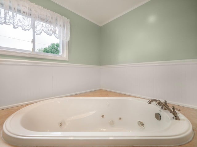 121 Bogert Ave, Pearl River, NY 10965 - bathroom featuring lofted ceiling, a jetted tub, ornamental molding, and wainscoting
