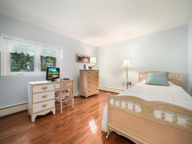 121 Bogert Ave, Pearl River, NY 10965 - bedroom with a baseboard radiator, wood finished floors, and a desk