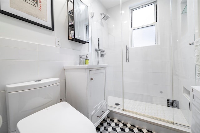 70 S Park Ave Unit 114, Rockville Centre, NY 11570 - bathroom with toilet, tile walls, vanity, and a stall shower