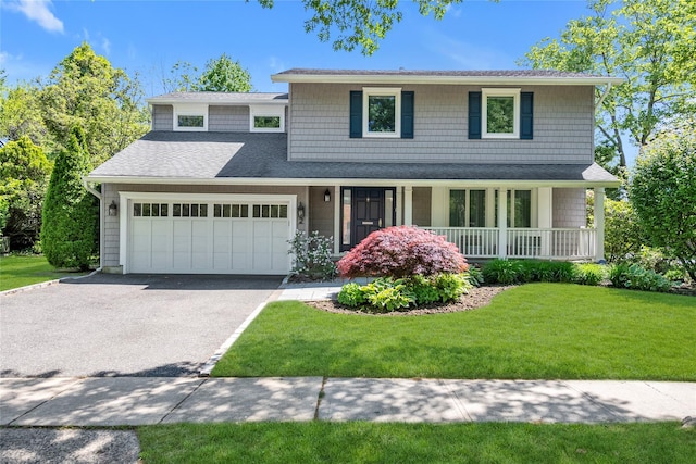 2 Driftwood Dr, Port Washington, NY 11050 - view of front of home featuring a garage, a porch, a front lawn, driveway, and a shingled roof