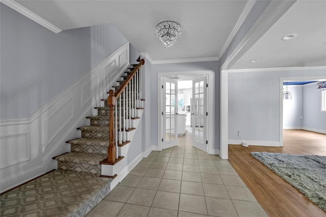 2 Driftwood Dr, Port Washington, NY 11050 - entryway featuring a chandelier, stairs, plenty of natural light, crown molding, and light tile patterned floors