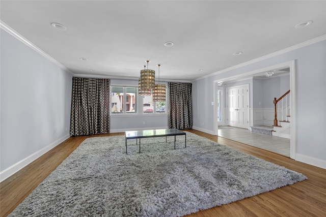 2 Driftwood Dr, Port Washington, NY 11050 - living room featuring a chandelier, ornamental molding, wood finished floors, stairway, and baseboards
