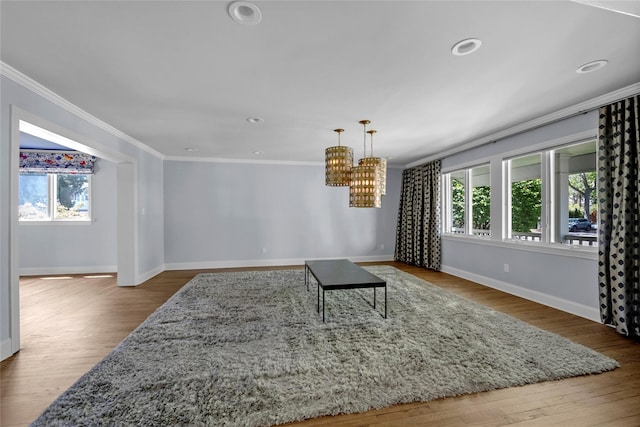 2 Driftwood Dr, Port Washington, NY 11050 - living room with plenty of natural light, ornamental molding, baseboards, a chandelier, and wood finished floors
