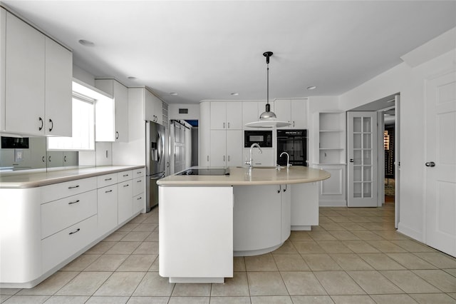 2 Driftwood Dr, Port Washington, NY 11050 - kitchen with black appliances, a sink, light countertops, and light tile patterned floors