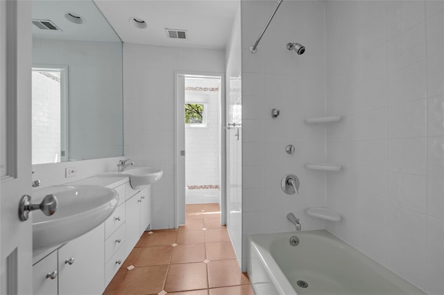 2 Driftwood Dr, Port Washington, NY 11050 - bathroom with double vanity, tile patterned floors, washtub / shower combination, and tile walls