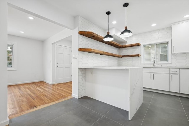 50 Christabel St, Lynbrook, NY 11563 - kitchen with open shelves, white cabinetry, recessed lighting, tasteful backsplash, and hanging light fixtures