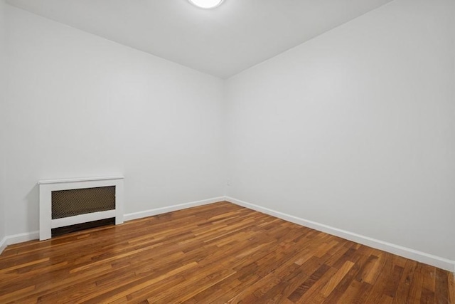 50 Christabel St, Lynbrook, NY 11563 - unfurnished room with radiator heating unit and wood finished floors