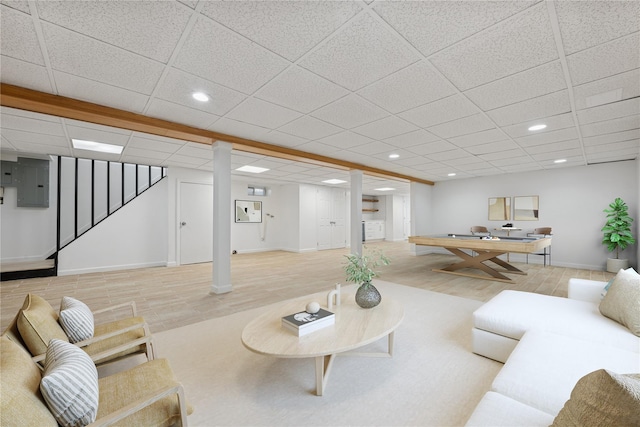 50 Christabel St, Lynbrook, NY 11563 - living area featuring electric panel, recessed lighting, wood finished floors, stairs, and a paneled ceiling