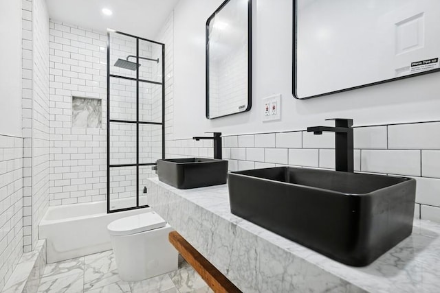 50 Christabel St, Lynbrook, NY 11563 - full bathroom featuring marble look tile flooring, recessed lighting, tile walls, and  shower combination