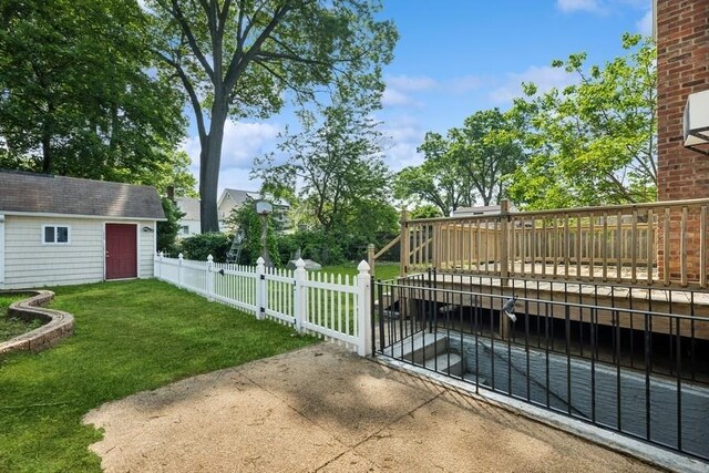 50 Christabel St, Lynbrook, NY 11563 - fenced yard with an outdoor structure and a deck