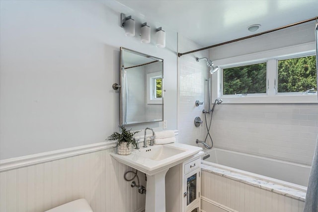 130 Sands Point Rd, Sands Point, NY 11050 - bathroom featuring bathing tub / shower combination, a sink, toilet, and a wainscoted wall