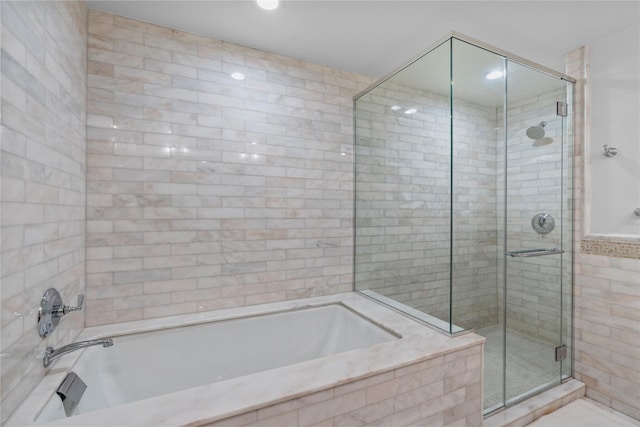 1 Renaissance Sq Unit 10H, White Plains, NY 10601 - bathroom featuring a shower stall and a garden tub
