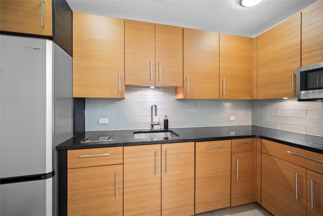 1 Renaissance Sq Unit 10B, White Plains, NY 10601 - kitchen with stainless steel appliances, a sink, backsplash, and dark stone counters