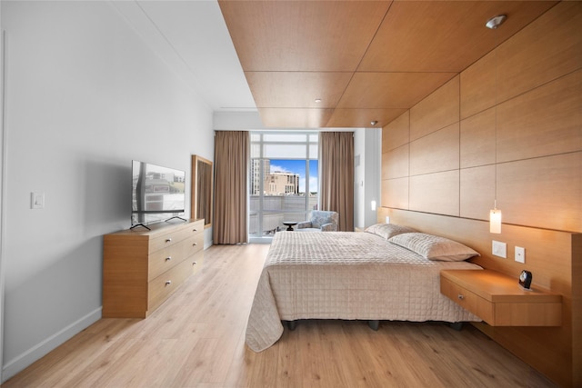 1 Renaissance Sq Unit 10B, White Plains, NY 10601 - bedroom with a wall of windows, light wood finished floors, and baseboards