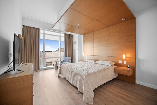 1 Renaissance Sq Unit 10B, White Plains, NY 10601 - bedroom with expansive windows, light wood-style flooring, and baseboards