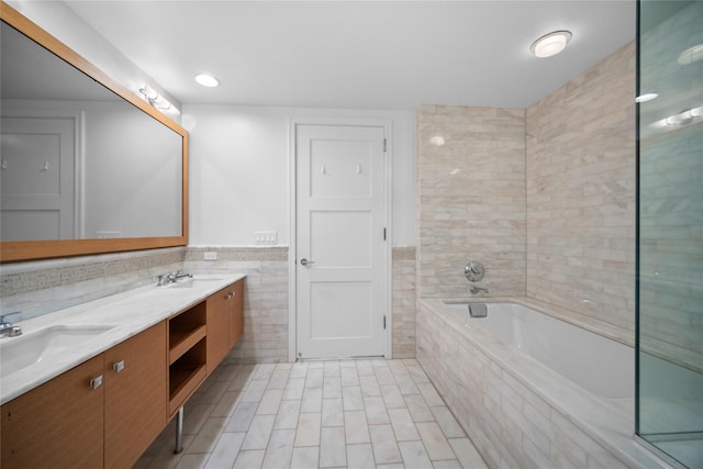 1 Renaissance Sq Unit 10B, White Plains, NY 10601 - full bathroom with tile walls, double vanity, a bath, and wainscoting
