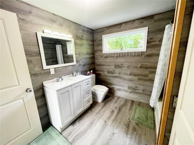 37 Starr Ave, Monticello, NY 12701 - full bathroom with toilet, vanity, wooden walls, wood finished floors, and curtained shower