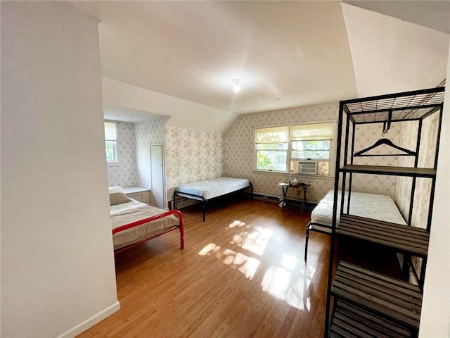 37 Starr Ave, Monticello, NY 12701 - bedroom featuring wallpapered walls, wood finished floors, baseboards, lofted ceiling, and cooling unit