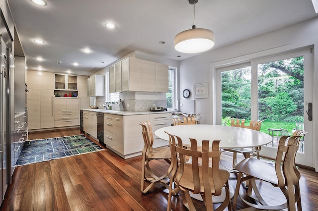 24 Cedar Ln, Sands Point, NY 11050 - kitchen with dark wood finished floors, light countertops, backsplash, dishwasher, and decorative light fixtures