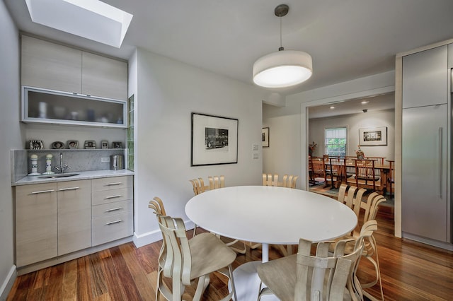 24 Cedar Ln, Sands Point, NY 11050 - dining area with a skylight, dark wood-type flooring, and baseboards