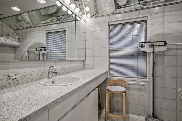 24 Cedar Ln, Sands Point, NY 11050 - bathroom with tile walls, vanity, and decorative backsplash