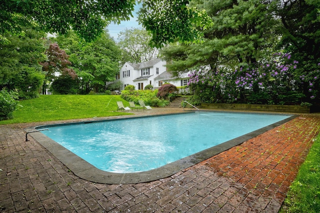 24 Cedar Ln, Sands Point, NY 11050 - swimming pool featuring a yard and a patio area