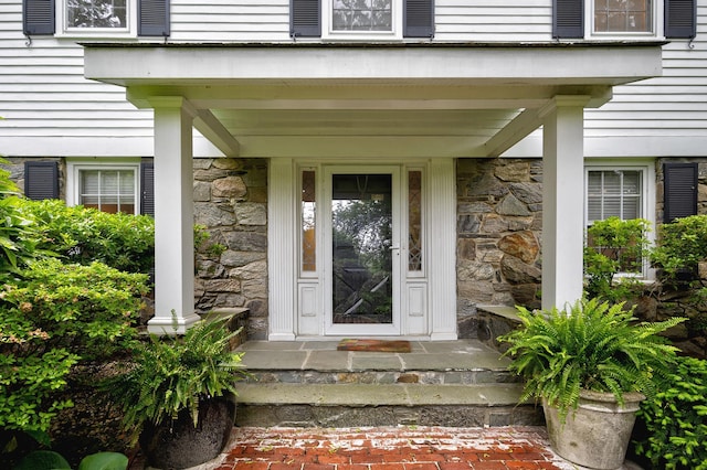 24 Cedar Ln, Sands Point, NY 11050 - view of exterior entry featuring stone siding